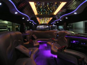 A bus with many seats and lights on the ceiling